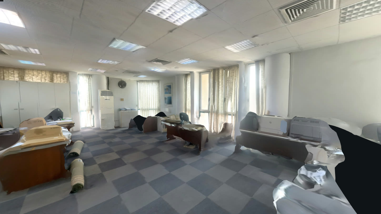 Interior of the fifth-floor office: open work floor with glazing along the far wall, suspended ceiling and checkerboard vinyl floor